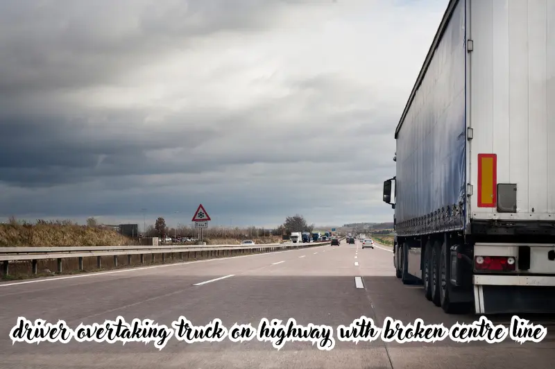 driver overtaking truck on highway with broken centre line