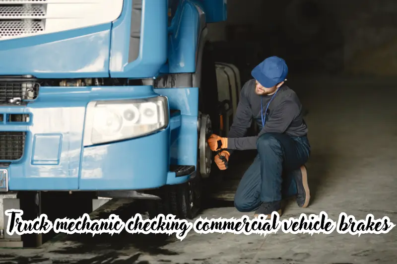 truck mechanic checking commercial vehicle brakes